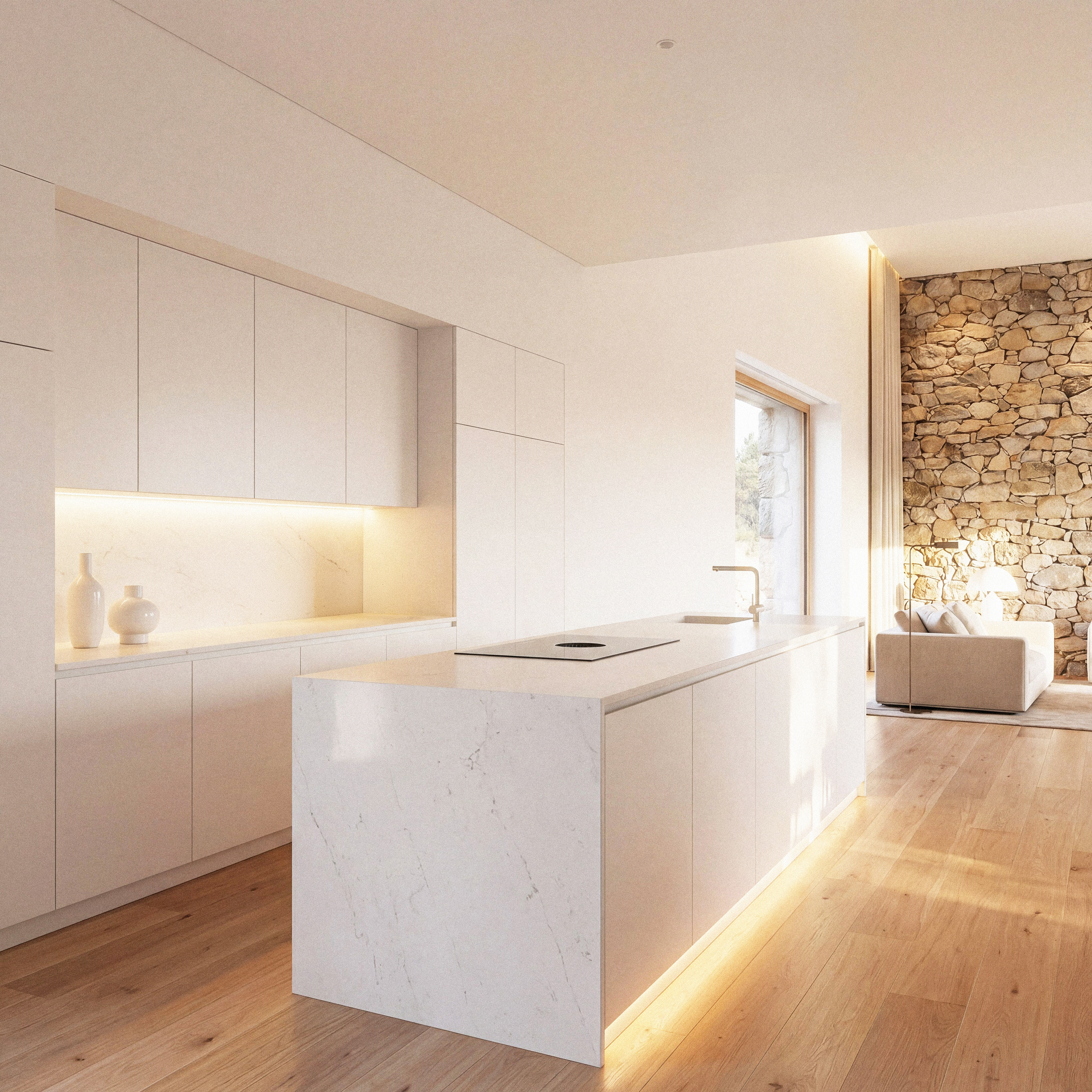Minho Kitchen — white island kitchen beside a stone wall